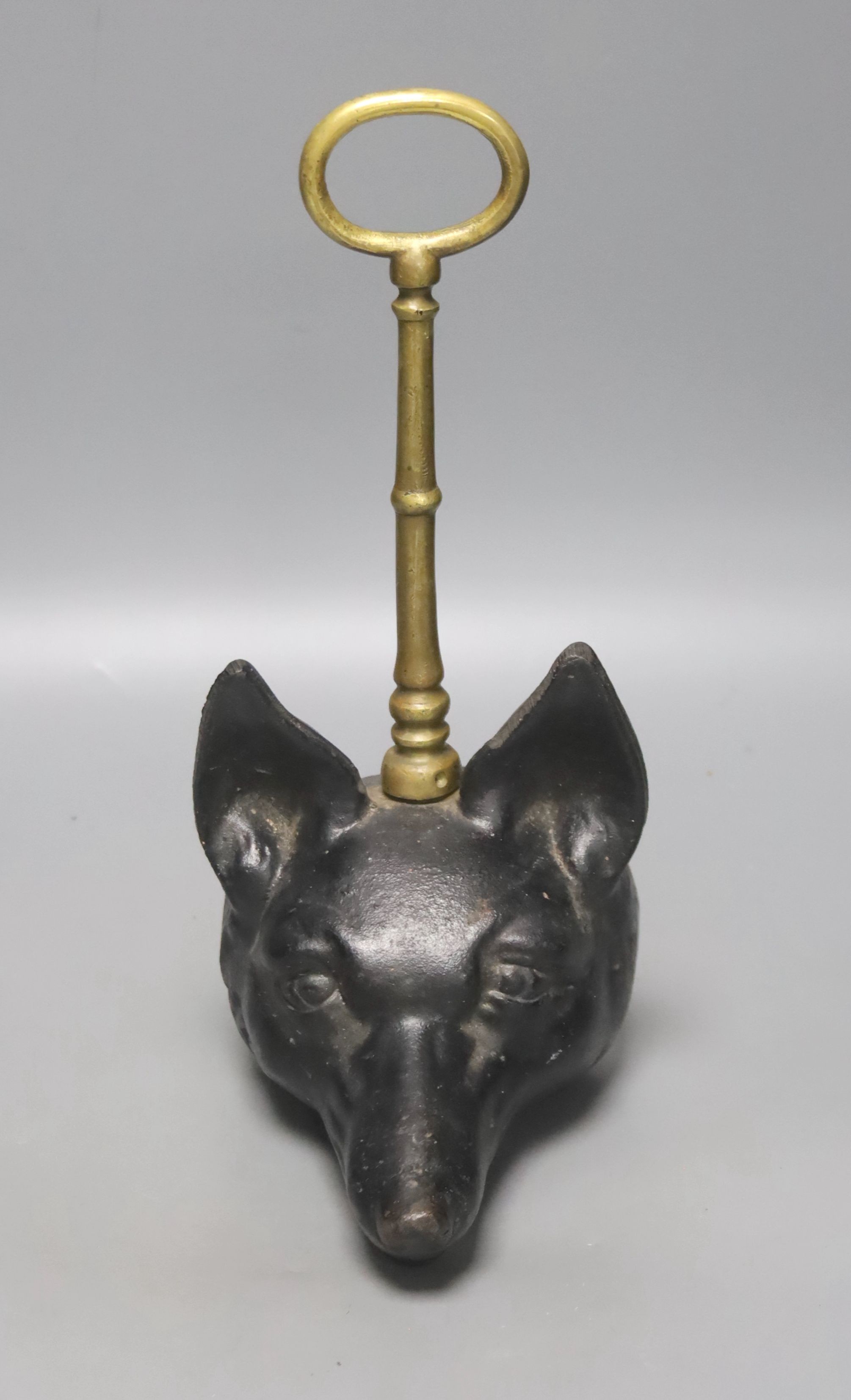 A cast iron and brass foxhead doorstop, 30cm tall